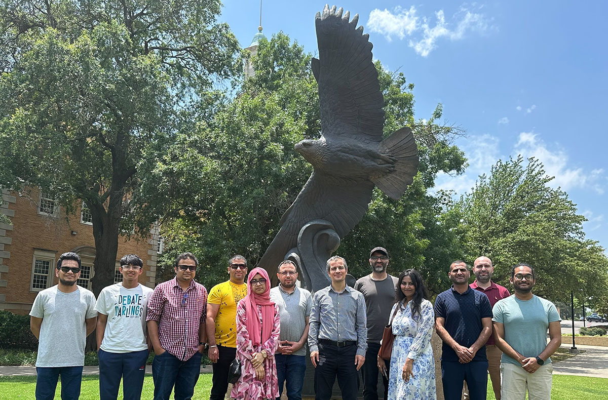 Group picture in front of UNT Eagle statue